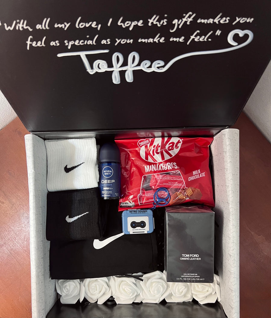 Toffee's box: Nike socks, Tom Ford Ombré Leather, KitKat, on white roses